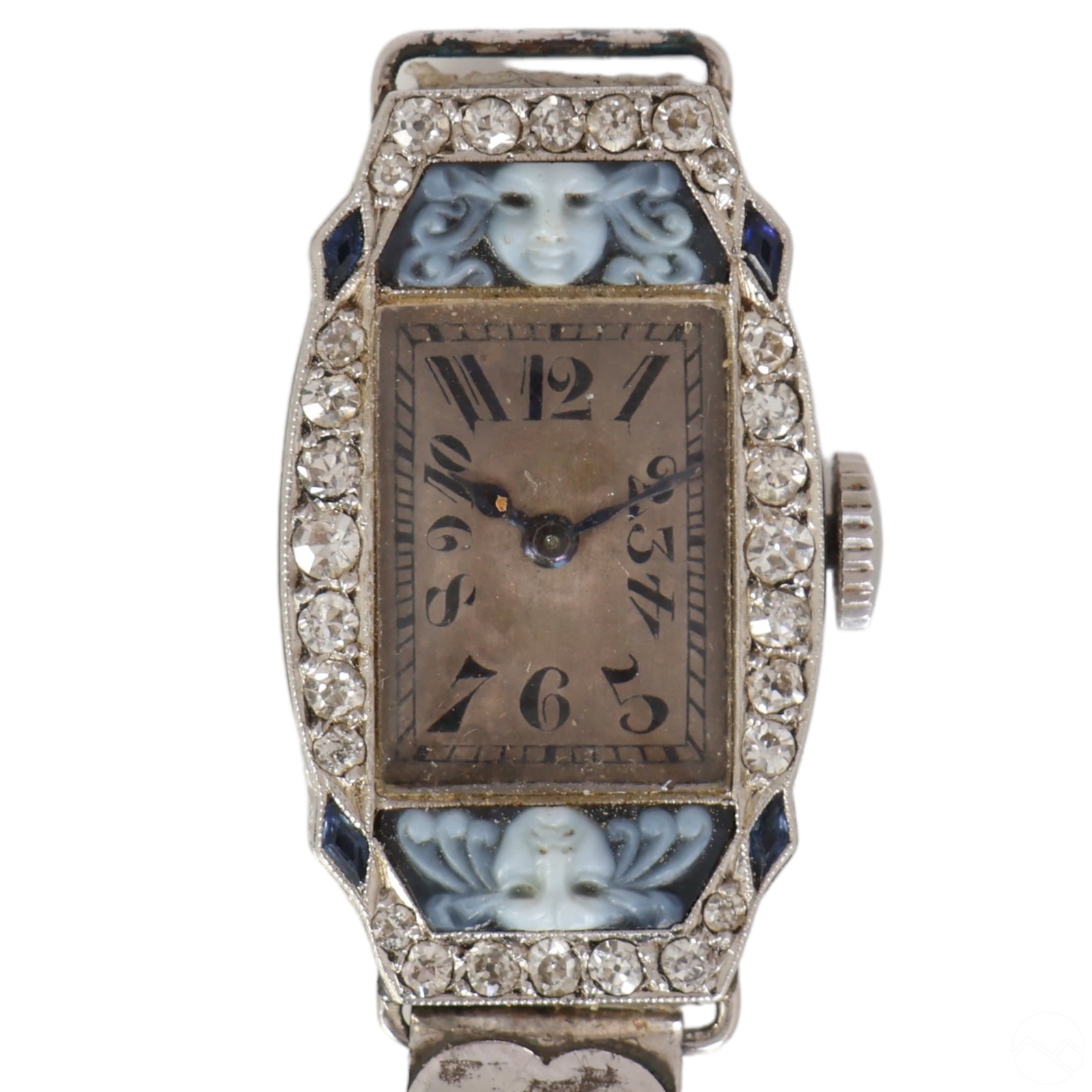 Platinum Diamond Cameo Antique Ladies Wrist Watch: An antique Art Deco ladies' platinum cocktail wristwatch adorned with diamonds, synthetic sapphires, and carved blue white cameos at each end of the watch face, featuring opposing frowning and smiling