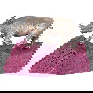 Asprey & Co of London Silver Model of a Rhino with Ruby Base: A finely crafted Wild Rhinoceros figurine by Asprey & Co. of London, positioned atop a natural Myanmar fluorescent ruby base. This exquisite silver sculpture showcases exceptional detail,