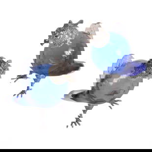 Pair Silverplate & Blue Art Glass Parrot Decanters: A pair of silver-plate and cobalt blue glass figural parrot bird decanters, featuring finely detailed silver-plated mounts and glass eyes. The bodies of the decanters are crafted from vibrant blue