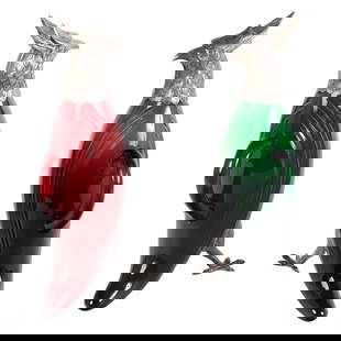 Spanish Silver Art Glass Bird Of Prey Decanters: This striking pair of Spanish silver and art glass figural decanters are designed in the shape of birds of prey, featuring vibrant red and green glass bodies. Each vessel is accented with detailed