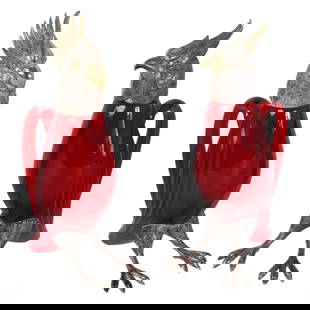 Cartier Pair of French Sterling Silver and Ruby Art Glass Bird Decanters: A charming pair of bird-shaped decanters, crafted from ruby-colored glass with sterling silver accents. One of the decanters is shaped like a cockatoo parrot and is marked "Cartier" on the neck,
