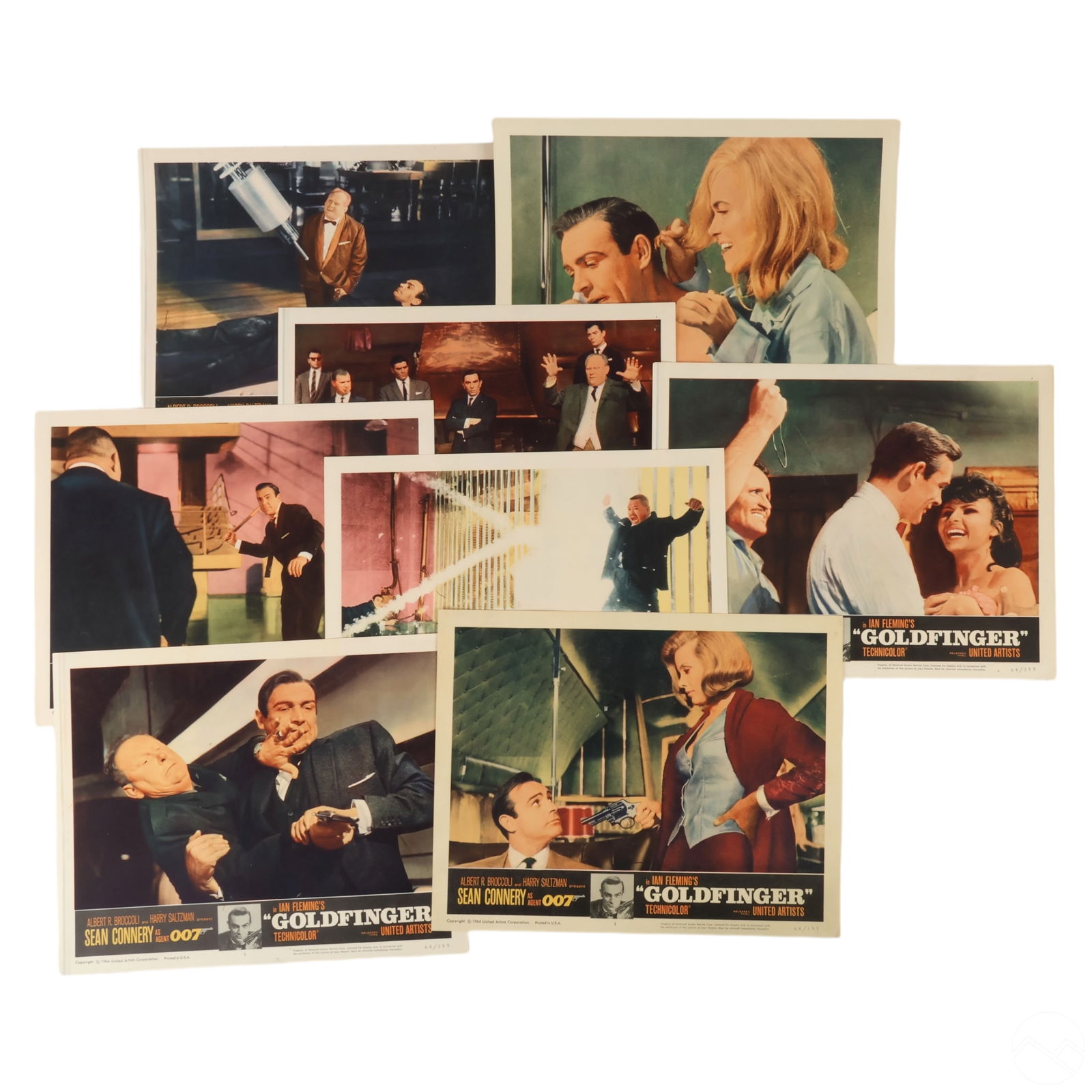 James Bond Goldfinger 8 Promotional Lobby Cards: A collection of promotional materials for the 1974 James Bond film The Man with the Golden Gun, starring Roger Moore as 007. The set includes a pressbook on the left, featuring stylized artwork with M