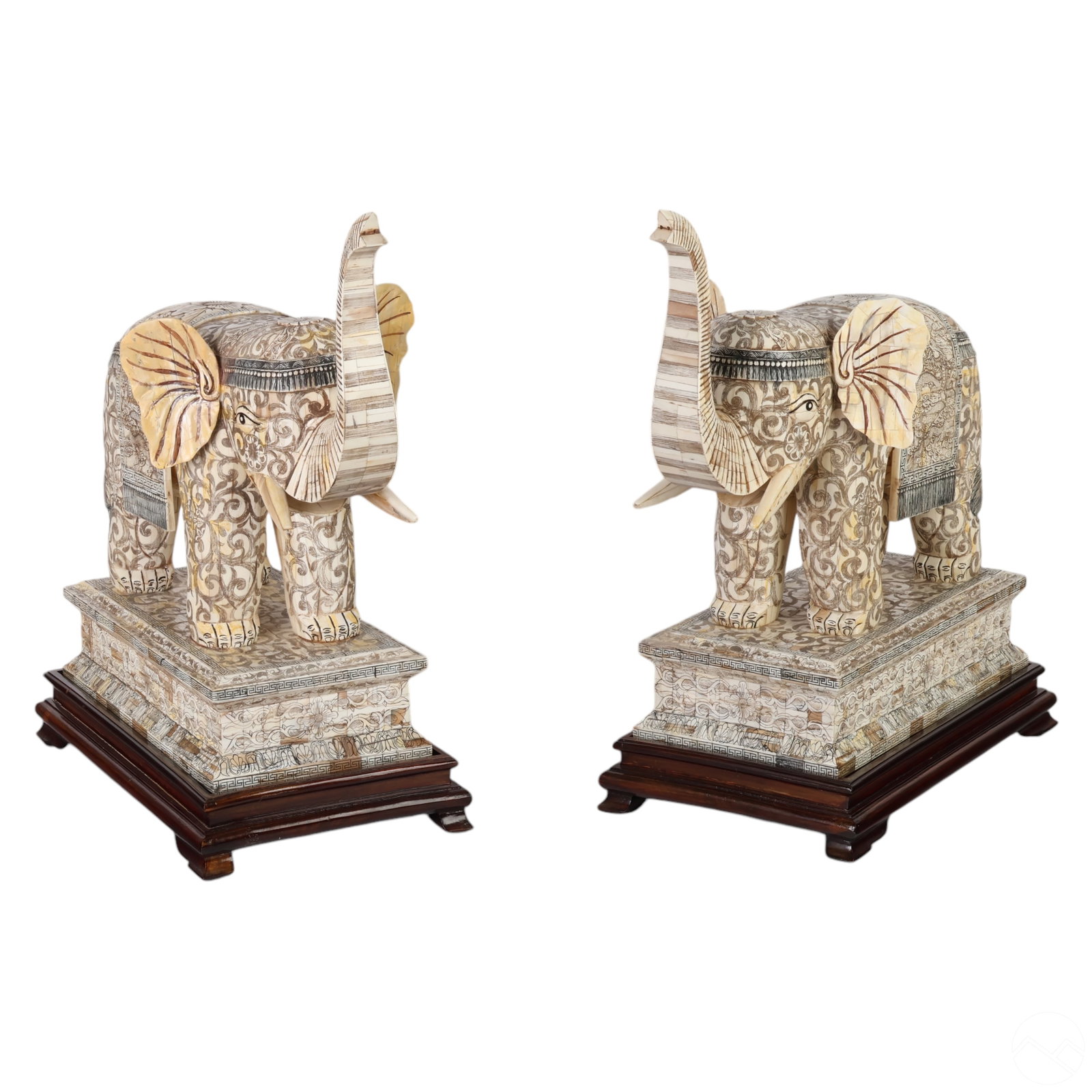 Chinese Pair of Scrimshaw Ox Bone Elephant Statues: A pair of finely crafted elephant statues, carved from ox bone and adorned with exquisite scrimshaw-style etchings of floral patterns and swirling designs. The long tusks and raised trunks convey gran