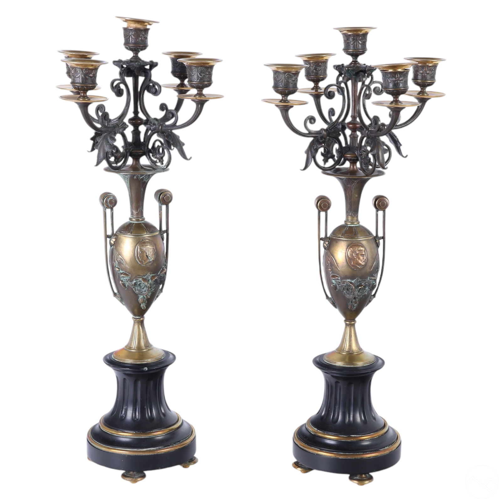 Egyptian Revival Pair of Bronze & Stone Candelabras: Antique pair of Egyptian Revival bronze and stone candelabras, each with a five-arm arrangement mounted on carved black slate pedestal bases. The amphora vase design features handles connecting the ba