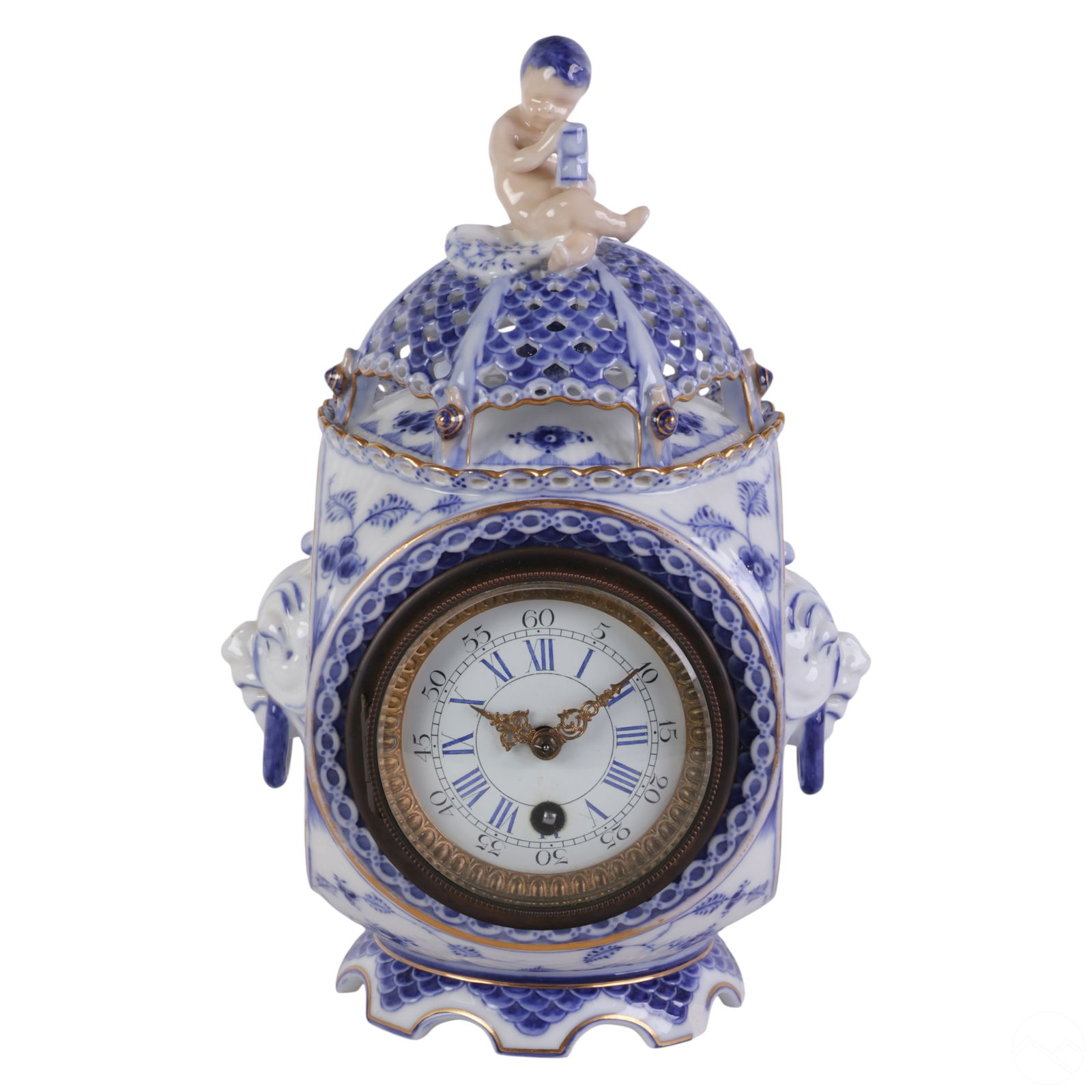 Royal Copenhagen Blue Fluted Full Lace Desk Clock: Danish Royal Copenhagen porcelain "Blue Fluted Full Lace" pattern shelf mantel clock featuring a blue and white floral design with gold accents. The openwork domed top is surmounted by a nude child ho