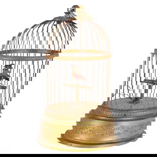 Antique French Automation Caged Musical Song Bird: Antique French mechanical singing bird automaton in a domed gilt metal cage. Features a feathered bird perched inside the cage, with floral garland relief around the base. Operated by a wind-up mechan