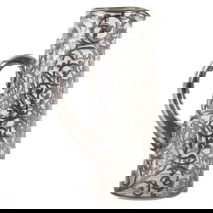Antique Art Nouveau Silver Overlay Glass Pitcher: Early 20th century Art Nouveau silver overlay glass pitcher with a cylindrical form. The clear glass body is fully encased in intricate scrolling foliate sterling silver overlay, featuring a monogramm