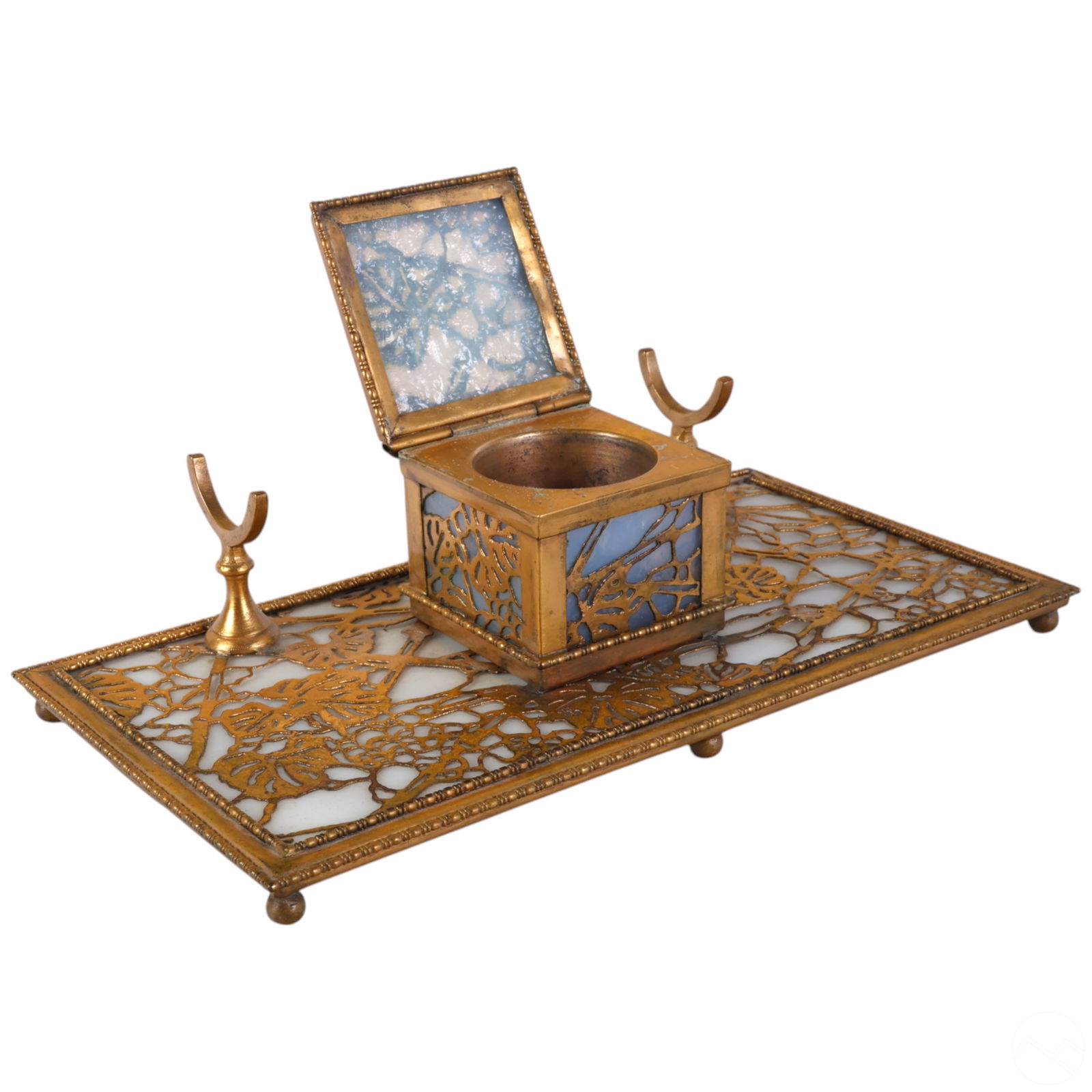 Riviere Studios Bronze and Glass Inkwell Pen Stand: Antique inkwell by Riviere Studios, composed of heavy cast bronze with ornate scrollwork and stylized detailing in a classical or Rococo Revival style. Features a hinged lid and a clear glass ink rese