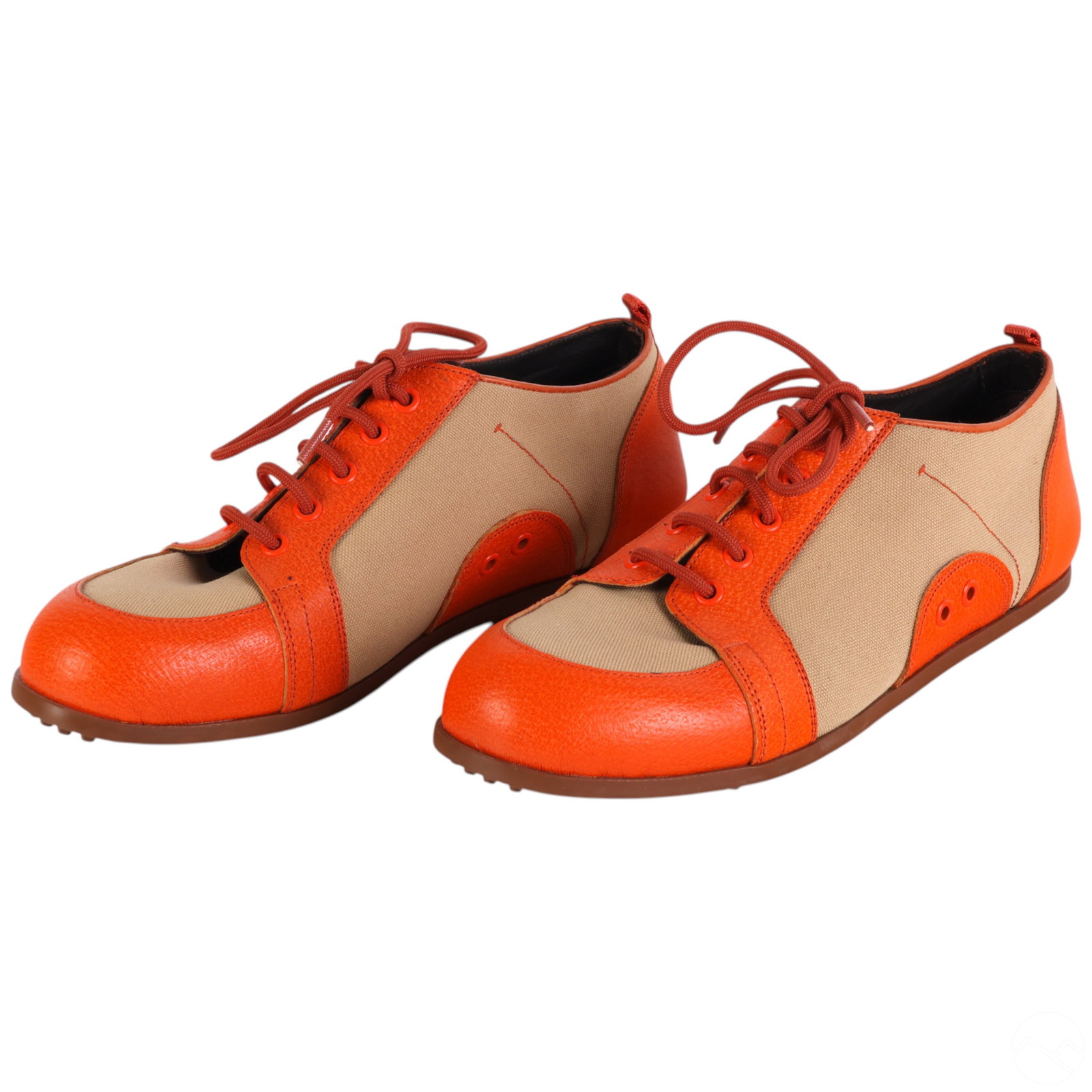 Prada Italian Orange Leather & Canvas Oxford Shoes: Pair of Prada women's size 7 low-top oxford sneakers crafted from burnt orange leather and tan canvas. The design features leather toe caps, heel panels, and lace guards, complemented by tan canvas si
