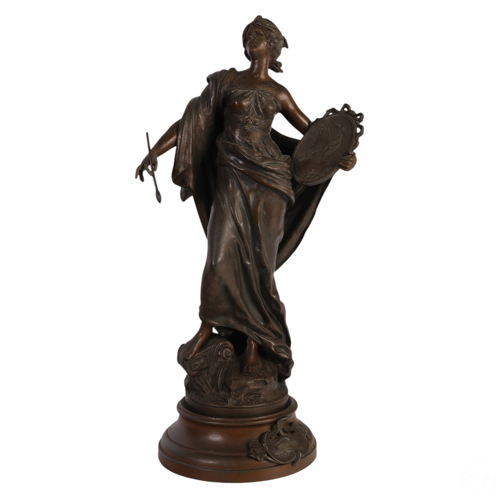 Bronzed Figural Muse Sculpture After Louis Moreau: Patinated bronzed metal sculpture After Louis Moreau depicting a classical muse in flowing drapery, rendered in the Art Nouveau style. The figure holds a painter's brush in one hand and a medallion fe