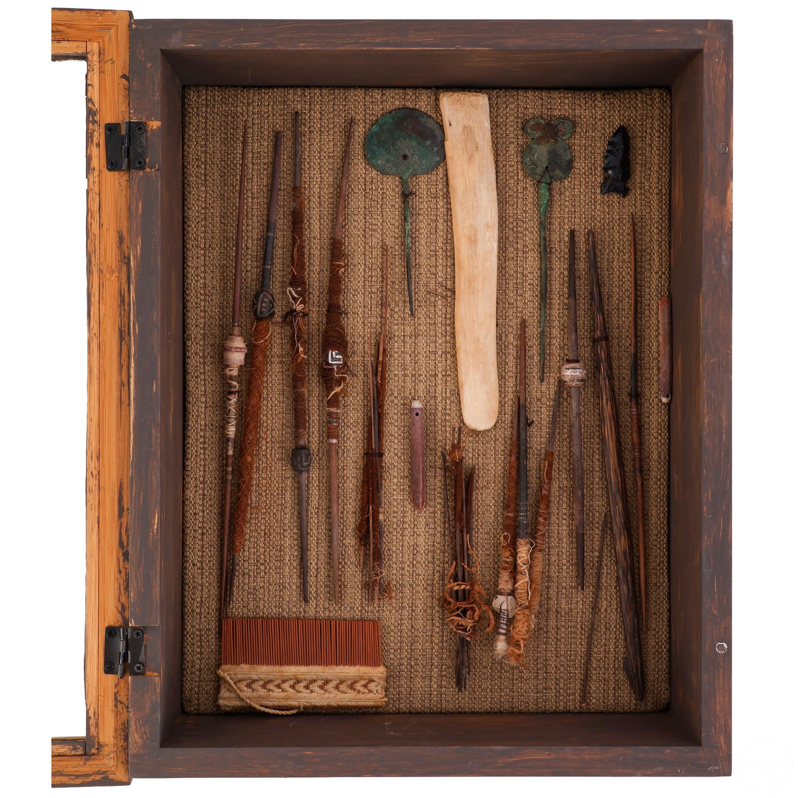 Pre-Columbian Style Textile Tool Estate Collection: Attributed to unknown makers, this curated collection of Pre-Columbian style implements is presented in a handcrafted wooden display box with a woven textile base. The assemblage includes wooden and b
