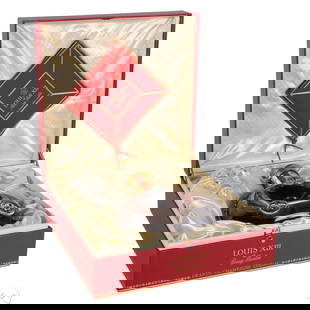 Sealed Louis XIII Remy Martin in Crystal Decanter: Bottle of Louis XIII by Remy Martin Grande Champagne Cognac presented in its original red leather box. The Baccarat crystal decanter features repousse fleur-de-lis medallions, a scalloped base, gilt n