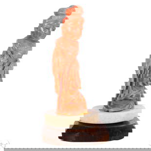 Chinese Carved Red Branch Coral Quan Yin Figurine: Chinese finely carved Guanyin (Quan Yin) figure rendered from natural branch coral in a soft salmon-pink hue. Depicted standing in flowing robes with hands clasped and hair arranged in a high chignon,