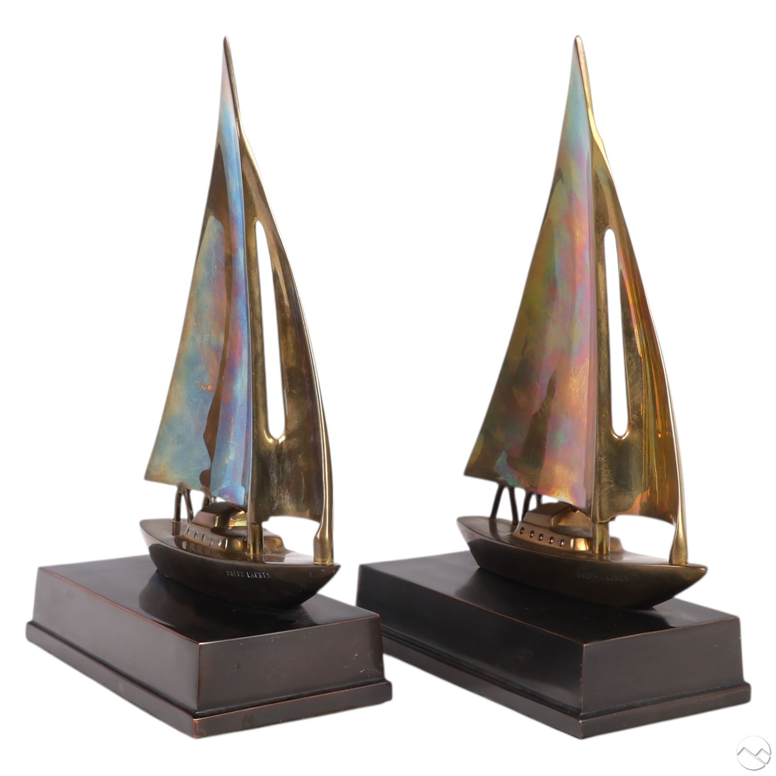 Ralph Lauren Brass Vintage Style Sailboat Bookends: Ralph Lauren RL pair of solid brass nautical sailboat bookends, each depicting a sleek yacht with billowing sails mounted on bronzed metal stepped bases. Both marked "RALPH LAUREN" along the hull.Dime
