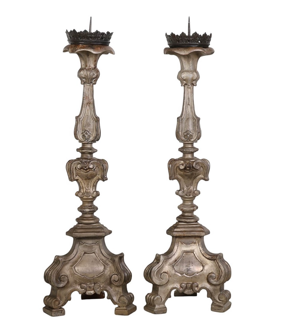 Pair of Antique Wooden Floor Pricket Candlesticks: Pair of antique Italian style floor pricket candlesticks each raised on a tripod base with Baroque style scrolling decoration. Topped with wide cast metal crown form drip pans fitted with central spik