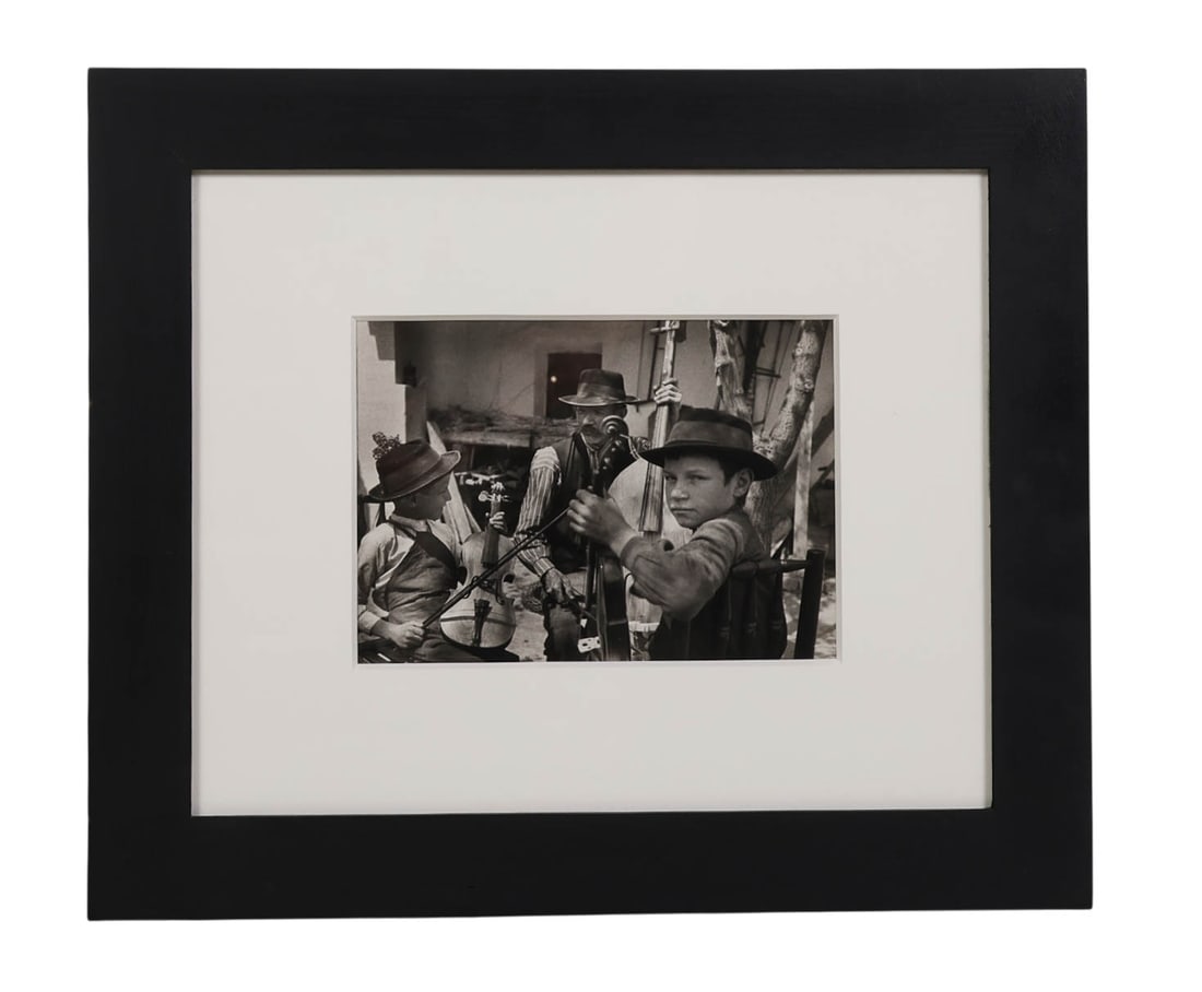 Andre Kertesz 1894-1985 Musicians Photo SIGNED: Andre Kertesz (French, 1894-1985), "Triosziget-Becse, Hungary," 1923. Gelatin silver print depicting a group of musicians with a child in the foreground. Signed on the verso. Provenance: Eaton Fine Ar