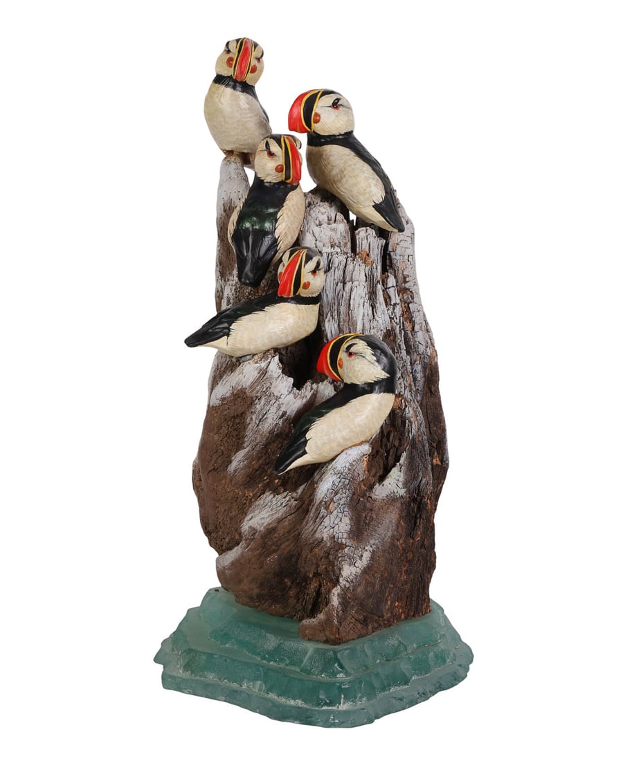 Colony of Puffin Auk Bird Sculpture on Driftwood: Wildlife nature sculpture depicting six puffin seabirds perched on driftwood styled as a rocky cliff. Each puffin is individually hand carved and painted in naturalistic cream, black, and iridescent t