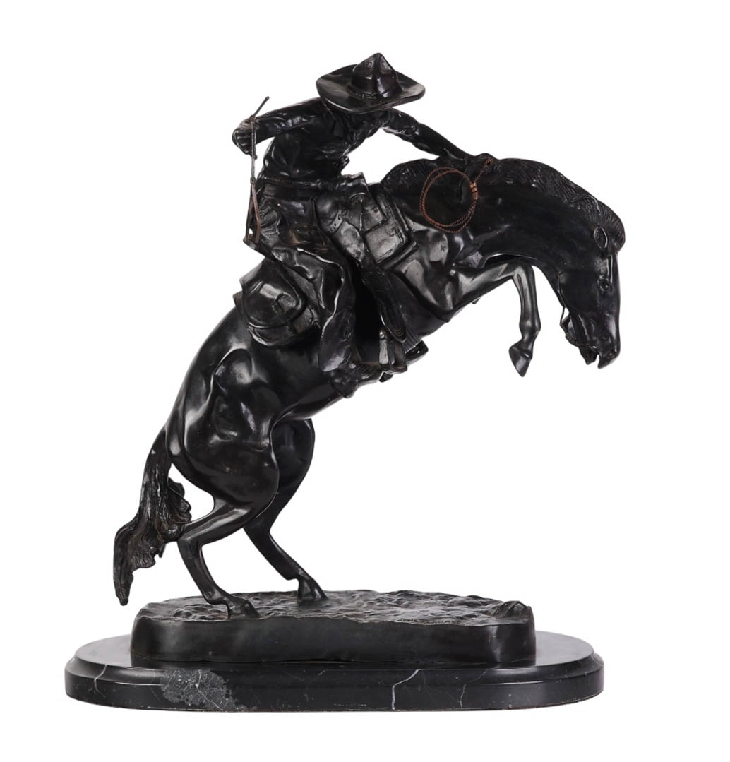 Bronze Bronco Buster Sculpture after F. Remington: After Frederic Remington (American, 1861-1909), bronze sculpture titled Bronco Buster. The work depicts a cowboy on horseback in mid-buck with lasso in hand, modeled in a dynamic pose with detailed We