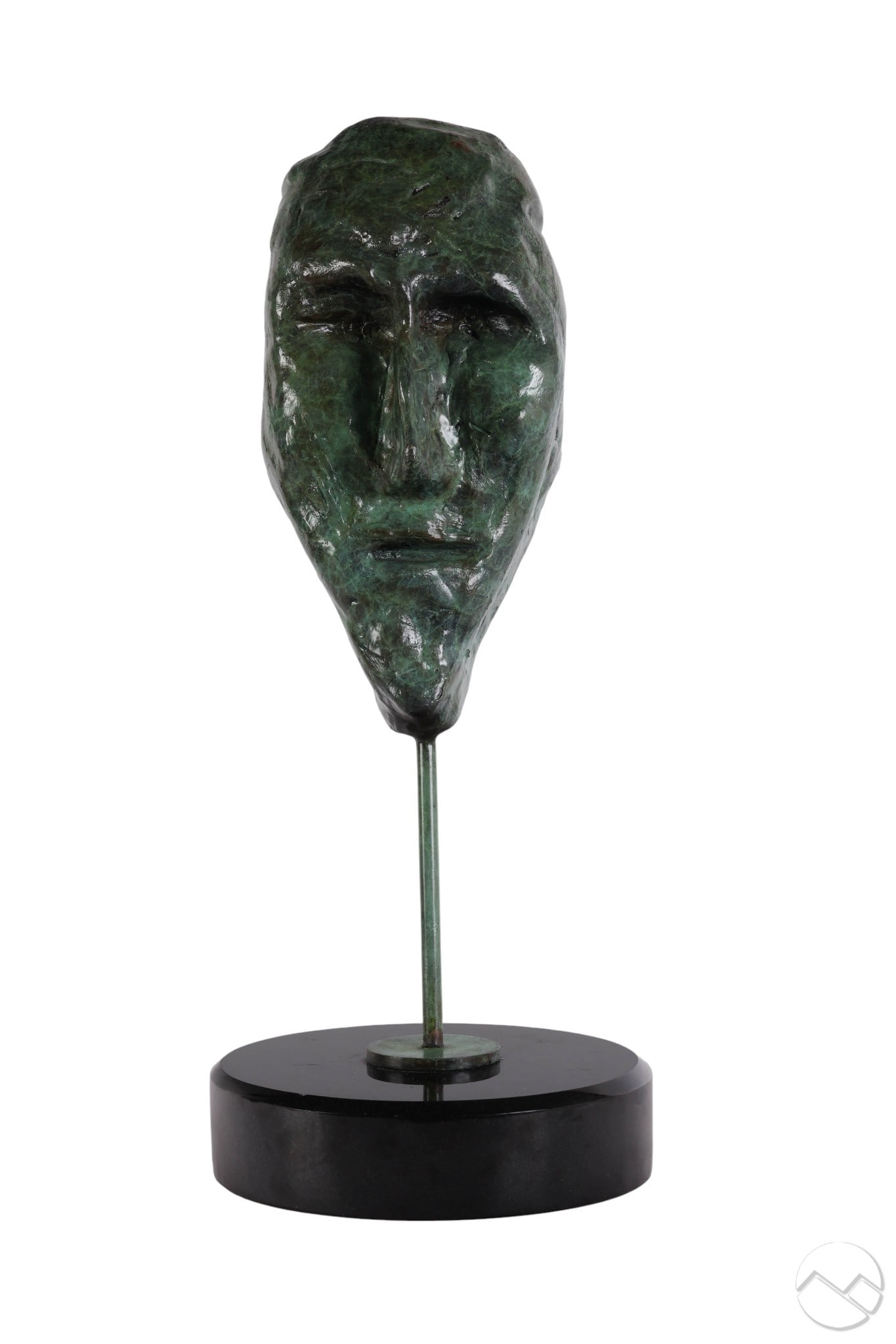 Jamali b.1944 Bronze Abstract Face Art Sculpture: Jamali (Pakistani American, born 1944), "Mask" sculpture featuring an elongated face rendered in heavily textured bronze with a green patina. Mounted on a black circular base with a vertical rod suppo