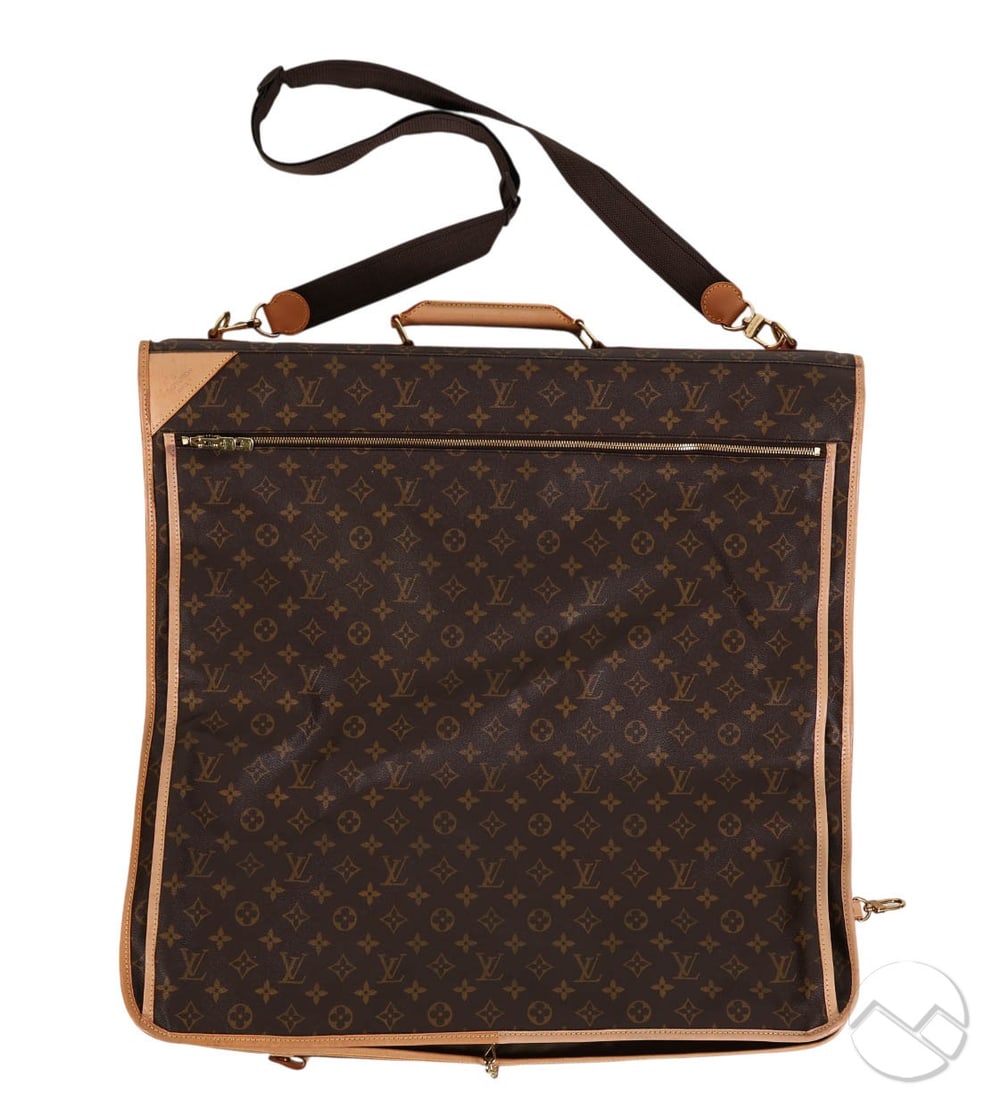 Louis Vuitton Monogram Canvas Travel Garment Bag: Louis Vuitton monogram logo canvas garment bag with cowhide leather trim and gold tone hardware. Opens to reveal a khaki textile interior with multiple zip compartments and clothing storage sections, 