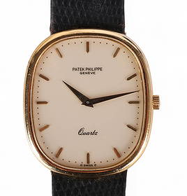 Patek Philippe Ellipse 3838 18k Gold Quartz Watch: Patek Philippe Ellipse wristwatch, reference 3838, crafted in 18k yellow gold and showcasing the brands signature elliptical case design. Measuring approximately 35mm x 30mm, this refined timepiece is