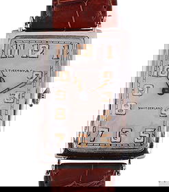 Patek Philippe for Tiffany & Co. 18K Gold Watch: Tiffany & Co. wristwatch by Patek Philippe featuring an elegant Art Deco-style rectangular case crafted in solid 18 karat white gold. The silver-tone dial is signed Tiffany & Co. and Swiss, and is app