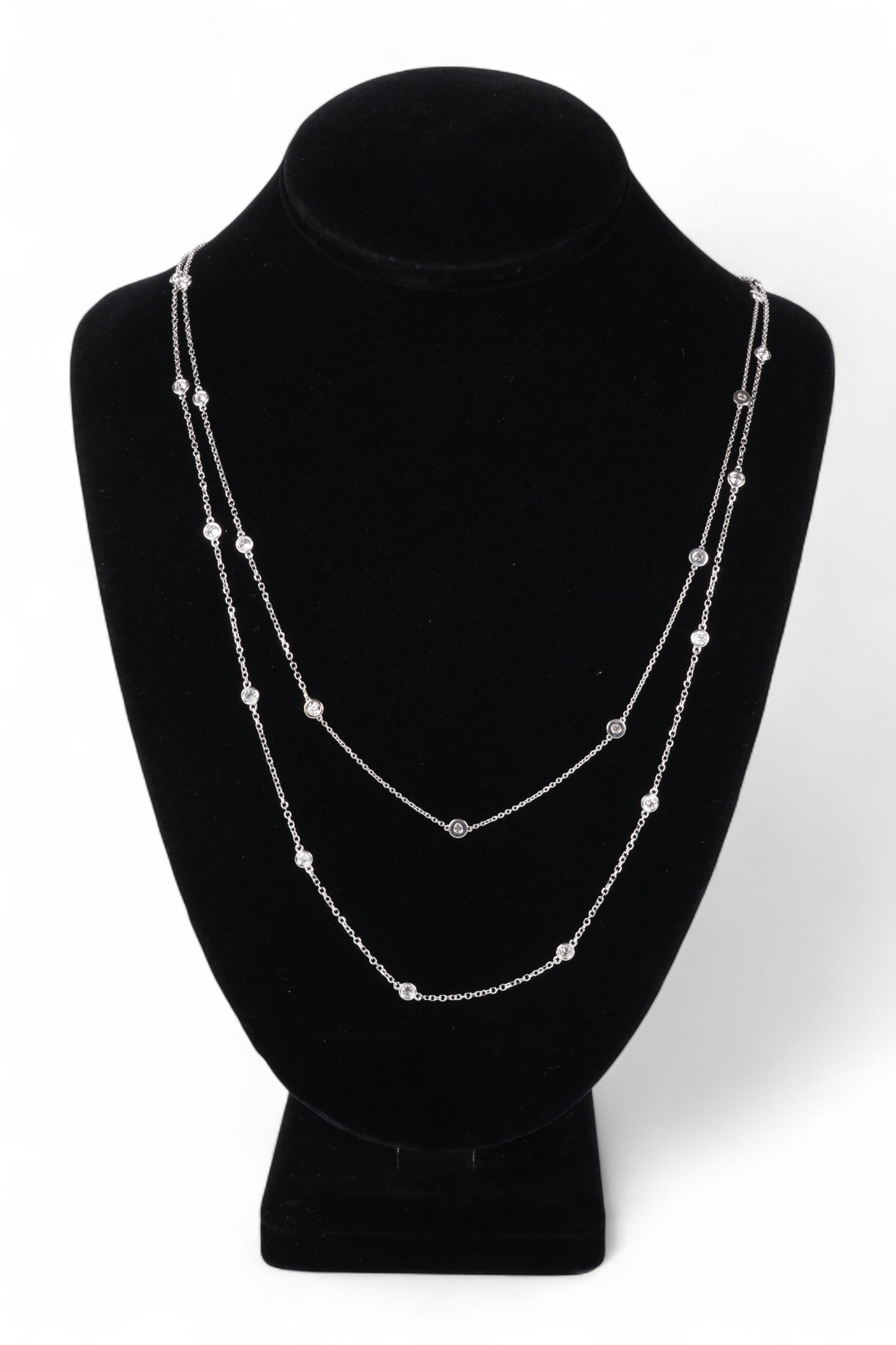 14k White Gold 3 CTTW Diamond By The Yard Necklace: Ladies' diamonds-by-the-yard necklace crafted in 14k white gold. The design features twenty-eight bezel-set round brilliant-cut diamonds totaling approximately 3.00 carats, judged to be G-H color and