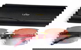 Cartier French Designer Eyeglass Sunglass Frames: Pair of Cartier France luxury designer rimless eyewear featuring gold-tone hardware and red wood-grain temples. The frames are signed Cartier and include a black Cartier hard case with a gold logo. Gl