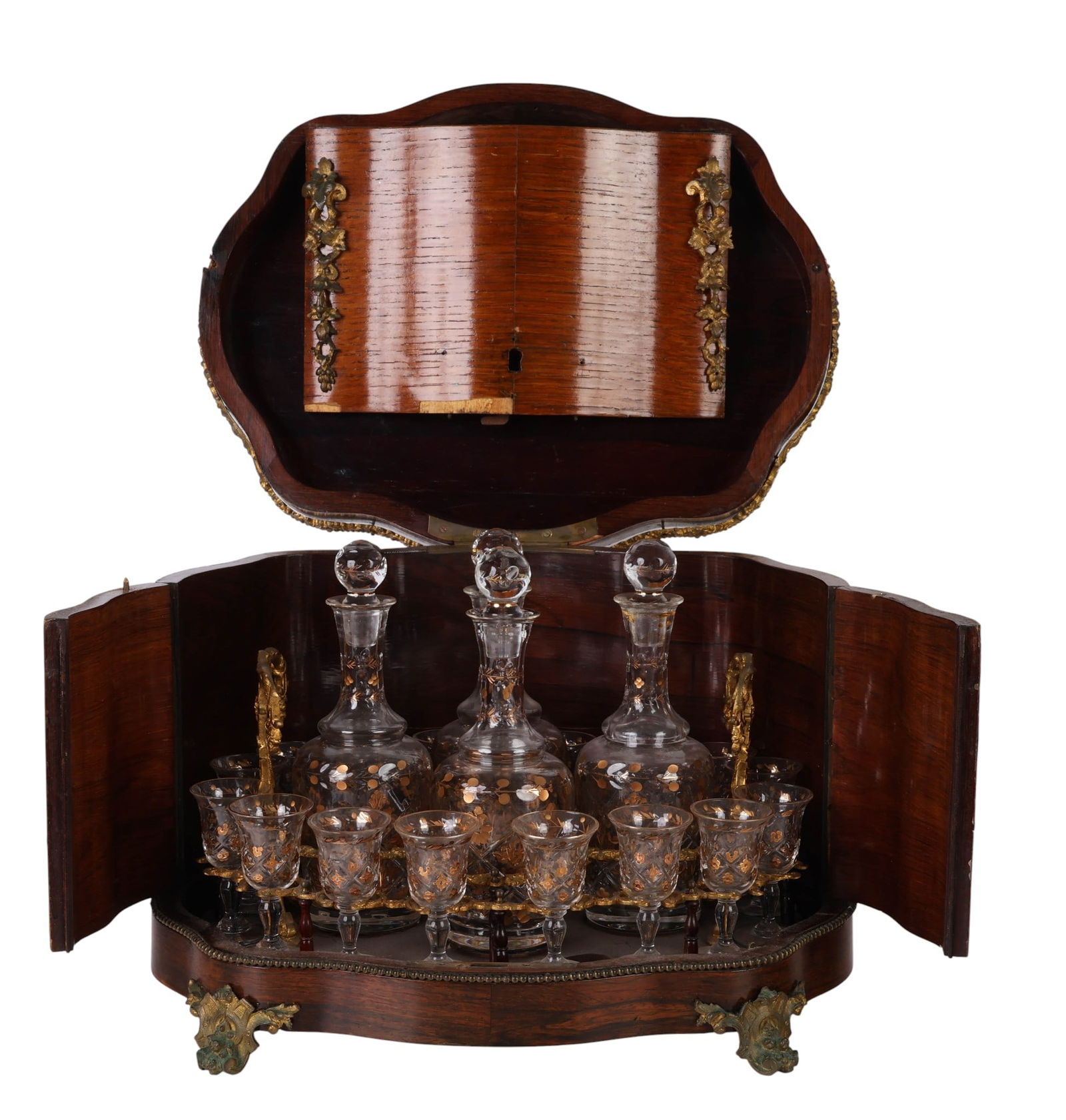 French Napoleon III Antique Tantalus Liquor Caddy: French antique 19th century Napoleon III Tantalus liqueur cabinet in serpentine form, crafted from mixed wood veneers and adorned with ormolu mounts, floral garlands, and beaded detailing. The hinged