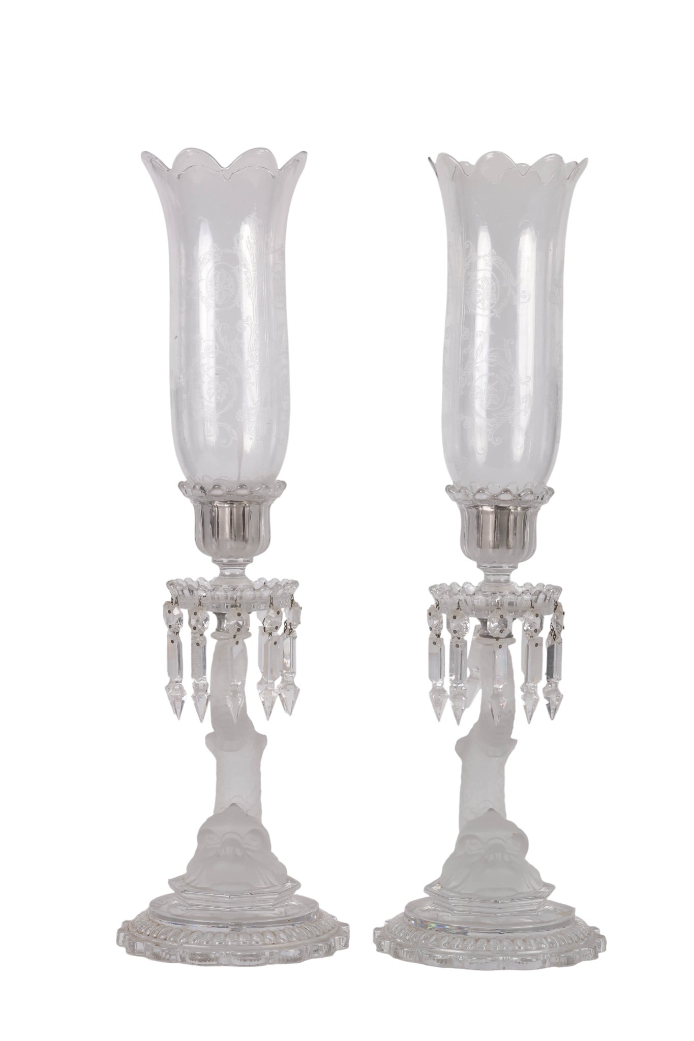 Baccarat Pair of Dolphin Hurricane Candlesticks: Pair of Baccarat French crystal hurricane candlesticks, featuring etched glass shades with scalloped ruffled rims and gently flaring petal-like curves. Adorned with faceted hanging prisms and frosted