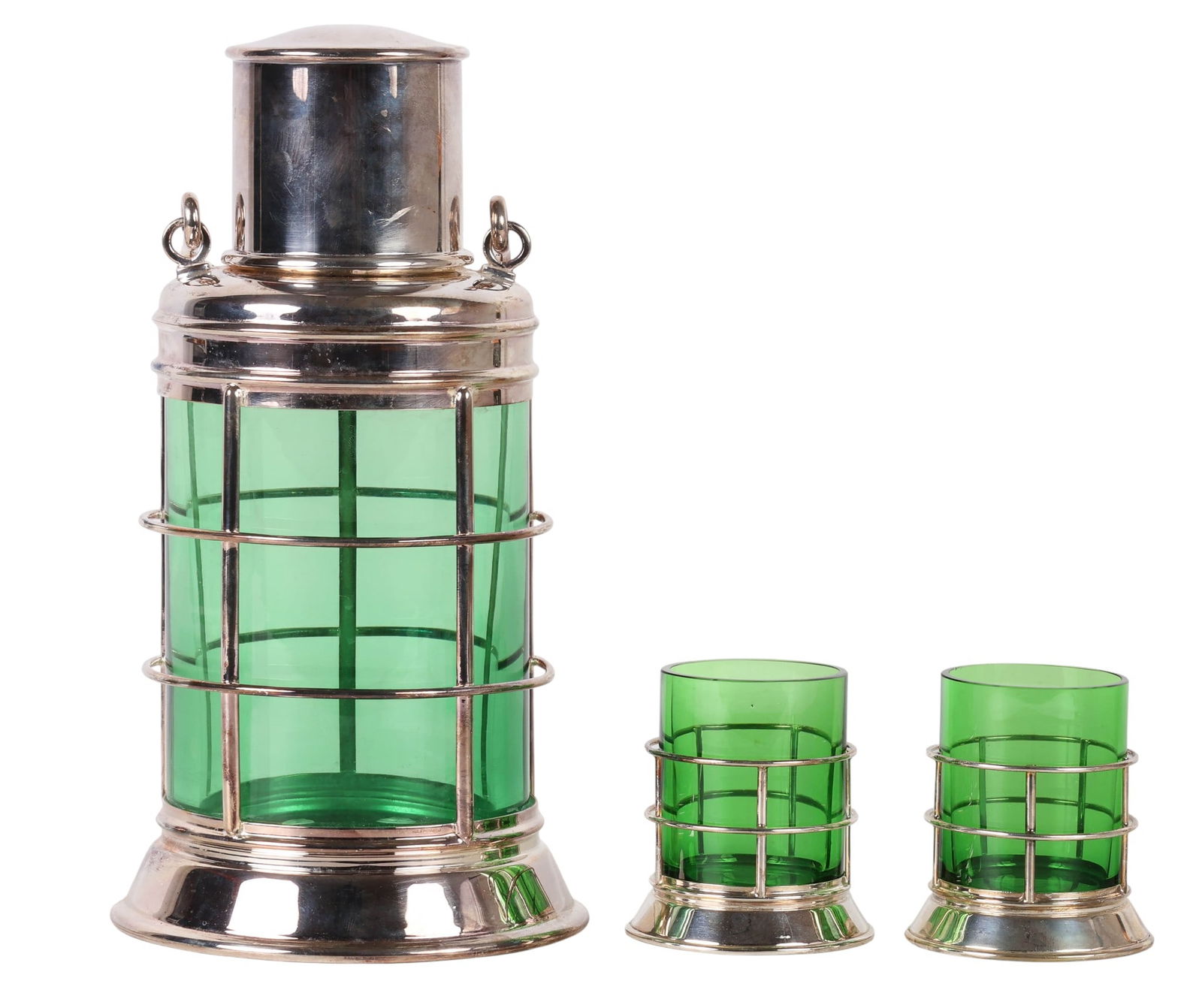 Asprey & Co Sterling Lantern Cocktail Shaker SET: Asprey & Co. sterling silver Ships Lantern cocktail shaker set. The shaker features emerald green glass mounted in silver, a removable lid with cork plug and built-in strainer, and hinged side handles