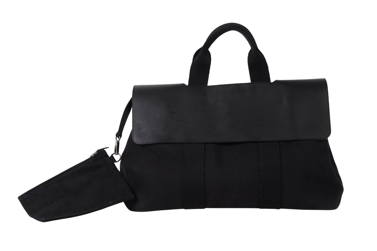 Hermes Black Canvas & Leather Flap Travel Tote Bag: Hermes luxury black canvas and leather travel tote bag with flap closure. Designed with durable web handles, a snap interior pocket, and a fabric-lined interior for organized storage. Interior tags ar