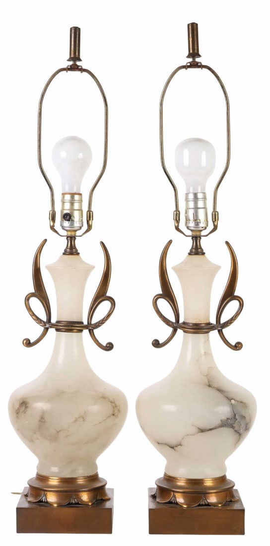 Pair of Mid Century Modern Alabaster Table Lamps: Pair of alabaster table lamps with metal mounts, each featuring a smooth bulbous body and an elongated neck flanked by stylized bronzed metal scrollwork handles. The lamps are supported on square step