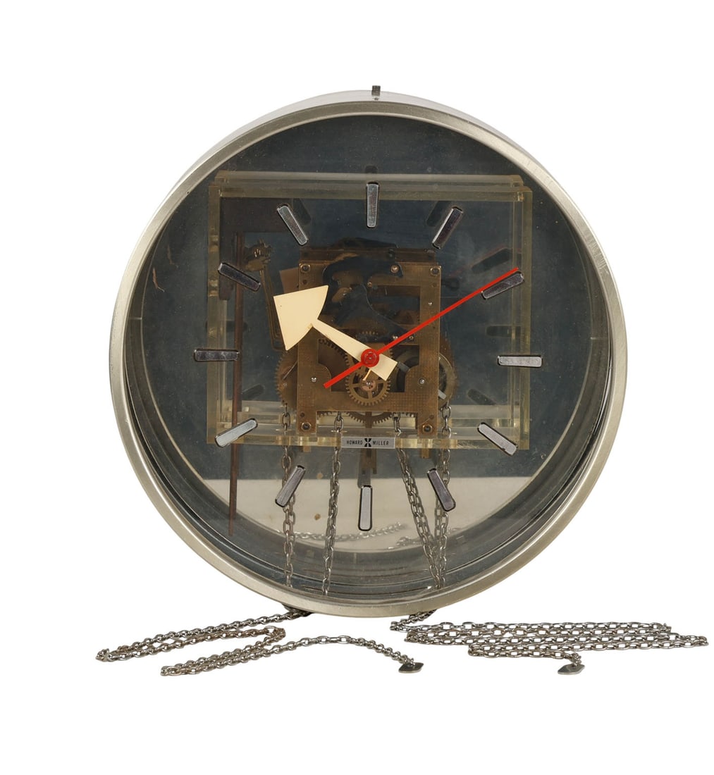 George Nelson for Howard Miller Mid Century Clock: George Nelson for Howard Miller wall clock with visible internal movement housed in a brushed metal circular case. Dial features applied hour markers arrow-shaped hands and a red seconds hand. Movemen