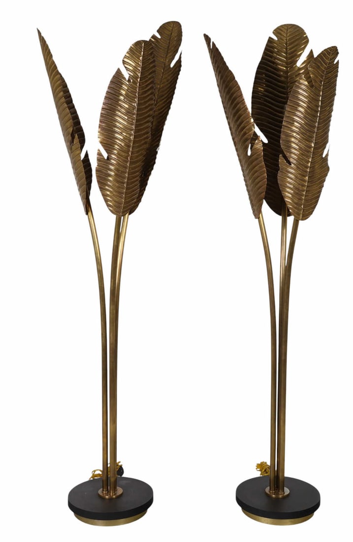 Palm Beach Regency Tropical Brass Palm Floor Lamps: Pair of Tropical Palm Beach Regency inspired modern designer metal floor lamps, each designed with three upright palm-shaped leaves extending vertically from round black bases. Each sculptural leaf su