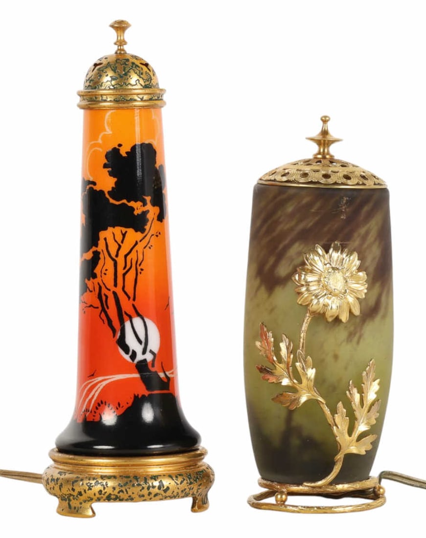 DeVilbiss & Daum Nancy Art Deco Boudoir Lamps LOT: Estate lot of two glass perfume boudoir electric lamps. Includes a DeVilbiss example with a painted landscape against an orange ground and a green colored frosted glass example with gilt brass floral