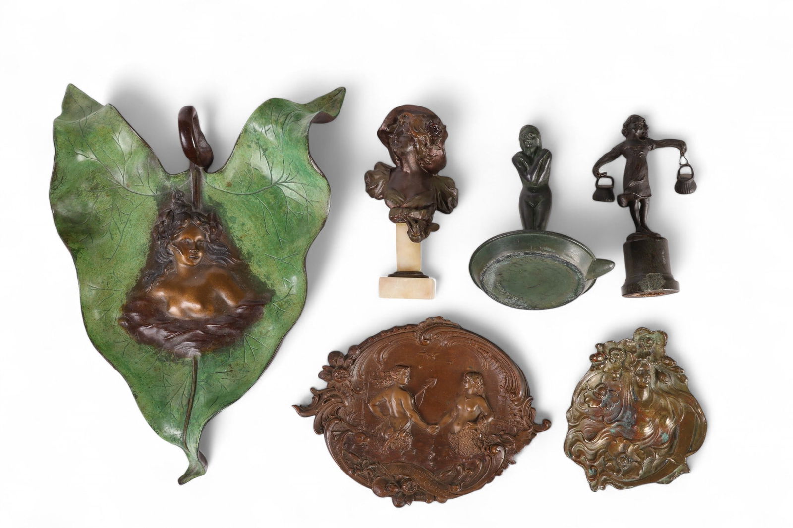 Art Nouveau Bronze Trays and Figures 6p ESTATE LOT: Lot of six Art Nouveau bronze decorative trays and small sculptures. The group includes a green-patinated bronze leaf-shaped tray with a raised nude figure, a bronze relief dish signed E. Harnisch wit