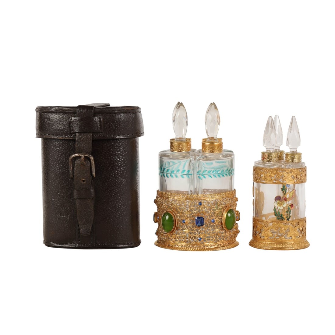 French Crystal Gold Gilt Travel Perfume Bottle LOT: Grouping of three French crystal clear glass vanity dresser scent bottle sets. Each includes faceted bottles with stoppers fitted into gold gilt pierced metal mounted holders. Two sets feature cases w