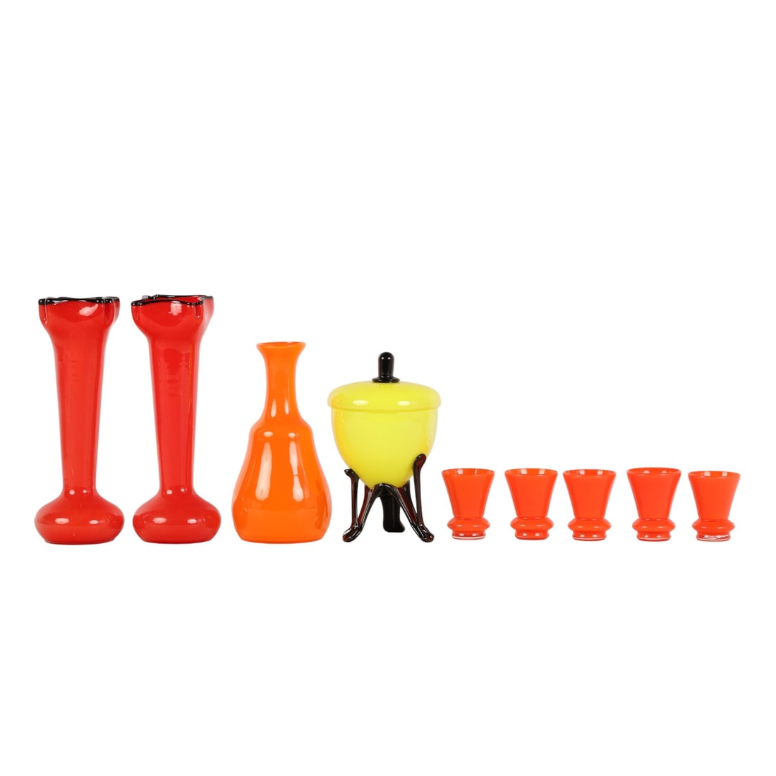 Bohemian Tango Shot Glass Vase Lidded Bowl 9pc LOT: Bohemian Czech estate lot of a total of nine art glass items including two red flared vases with black ruffled rims, one orange decanter bottle, five matching orange shot glass drinking glasses, and