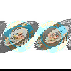 Antique French Sevres Porcelain Angel Plates LOT: Pair of French antique porcelain plates attributed to Sevres, each featuring a central hand-painted figural scene with putti surrounded by musical and floral elements, framed by gilt highlights. The t