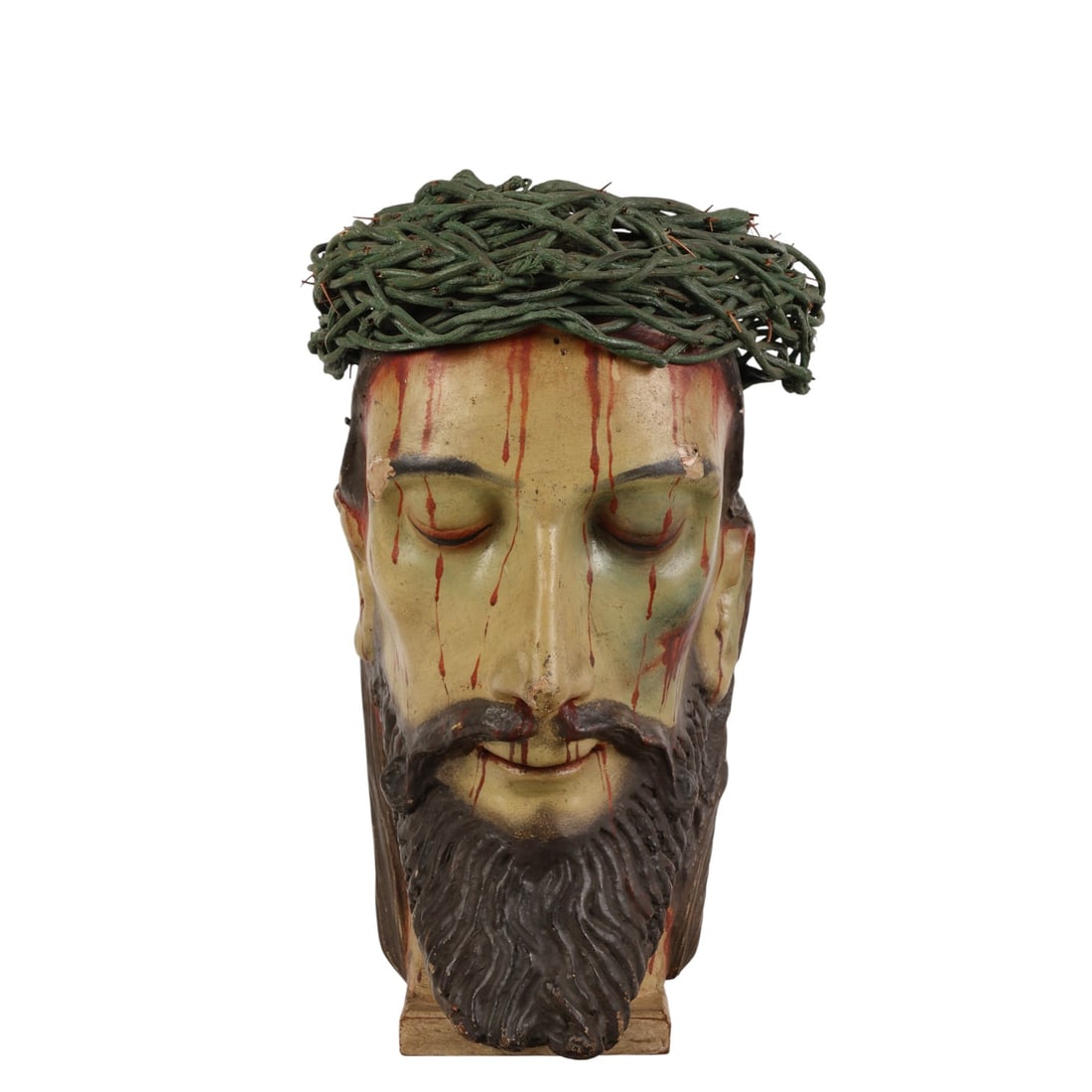 Antique Hand Painted Paper Mache Head of Christ: Early hand made papier-mache religious sculpture depicting the head of Jesus Christ with a crown of thorns, presented as a bust mounted on an integral square wood base. The sculpture features painted