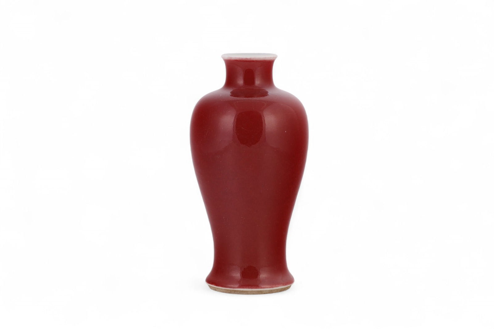 Chinese Sang De Boeuf Oxblood Glaze Porcelain Vase: Chinese porcelain vase of baluster form with flared rim and foot, covered in an oxblood (sang de boeuf) glaze having shades of lighter tones to the mouth and base. Interior and rim glazed in white. Un