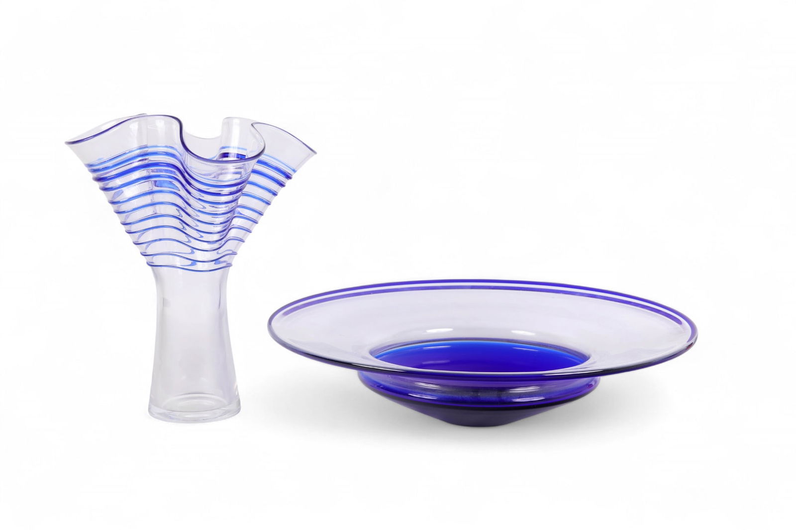 Art Glass Ruffled Vase and Centerpiece Bowl SIGNED: Late 20th century studio art glass, each signed and dated 1998. Includes a tall clear vase with cobalt blue horizontal ribbed striping and flared ruffled rim, together with a wide shallow bowl in