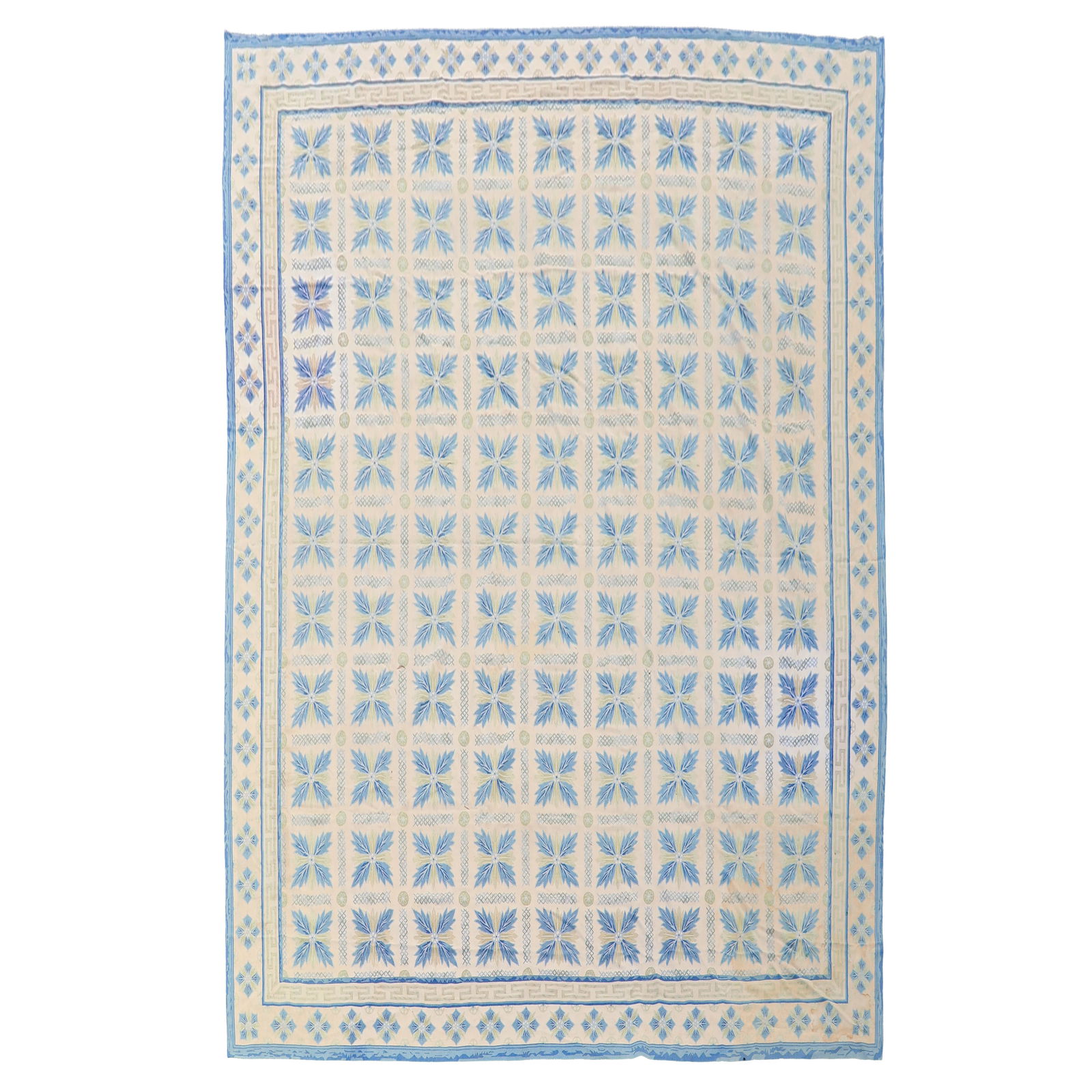 French Aubusson Flat Weave Tapestry Style Area Rug: French handwoven Aubusson-style large area carpet featuring an allover floral and geometric pattern arranged in a repeating grid, framed by a Greek key and floral border. The design is executed in bei