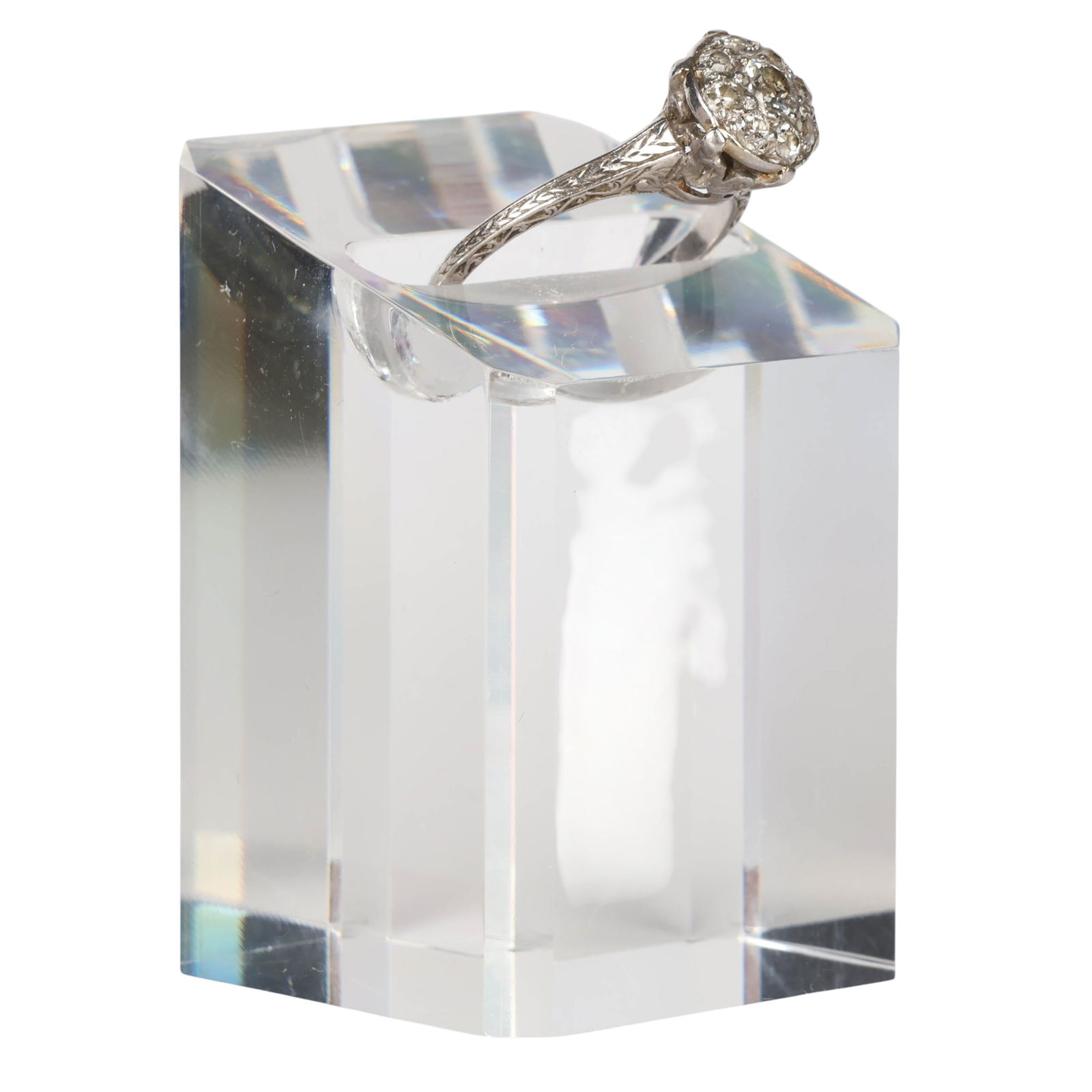 Antique White Gold and Diamond Cluster Ring Size 6: Antique white gold diamond cluster ring with a raised floral style head set with old cut diamonds. The engraved shoulders feature scrolling foliate decoration, tapering to a slender shank, consistent