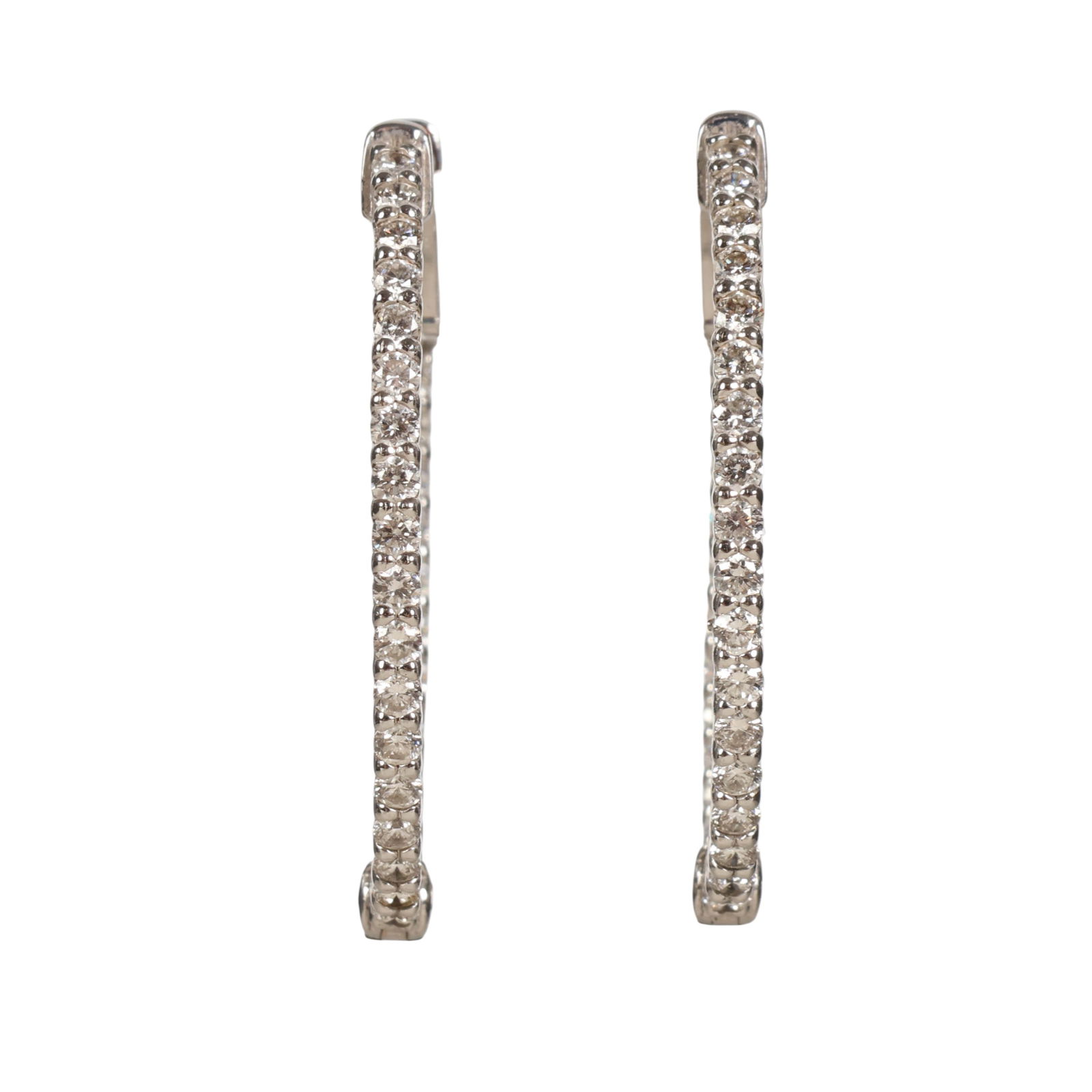 14k White Gold and Diamond Gemstone Hoop Earrings: Pair of 14k white gold diamond hoop earrings featuring a continuous row of round-cut diamond gemstones set along the front exterior and interior of each hoop, creating a full-circle diamond effect whe