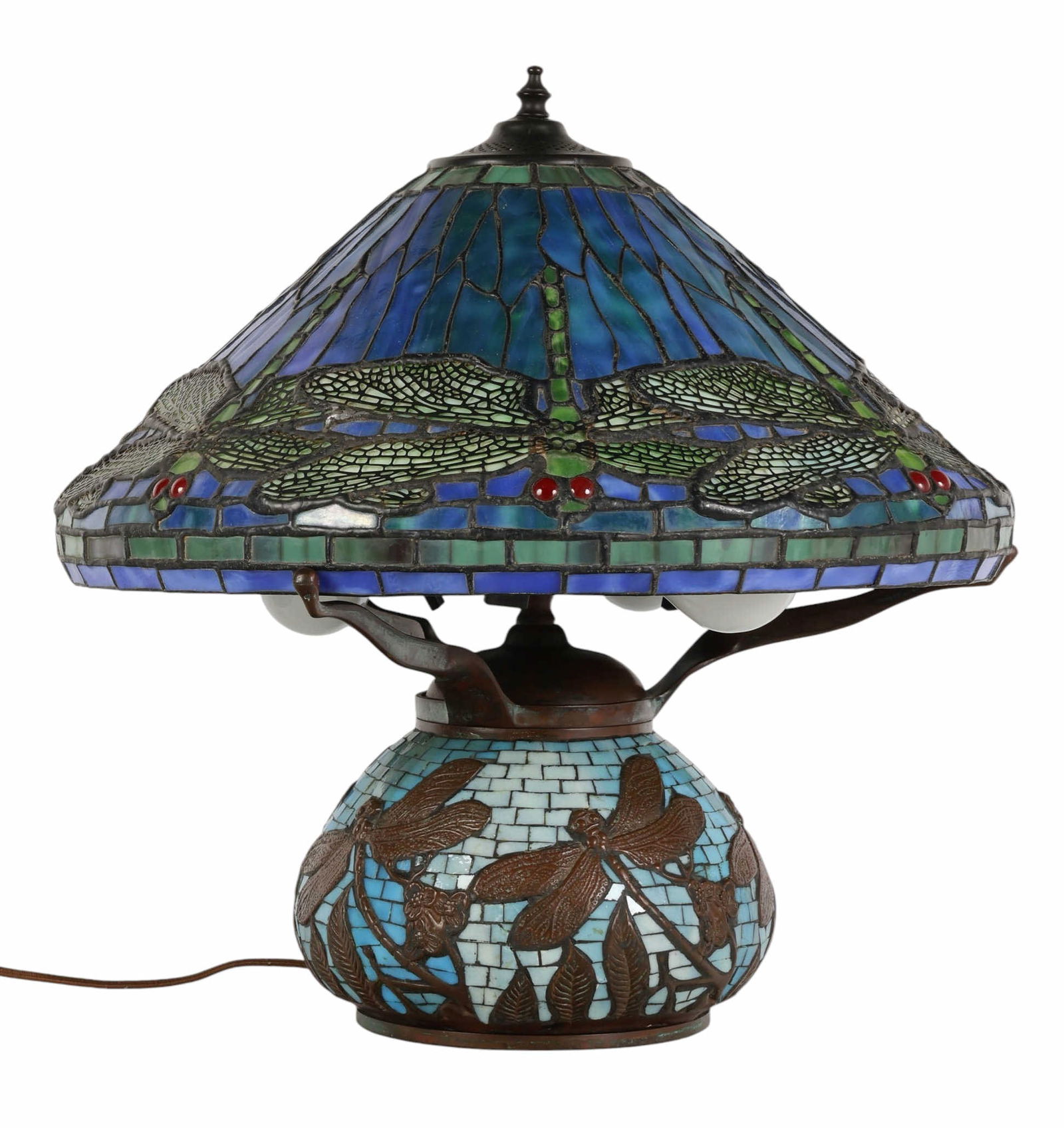 Leaded Glass Shade Dragonfly Tiffany Style Lamp: Tiffany-style table lamp featuring a leaded glass shade decorated with a repeating dragonfly motif, composed of cobalt blue, teal, and green glass panels with red jeweled eyes. The domed shade is supp