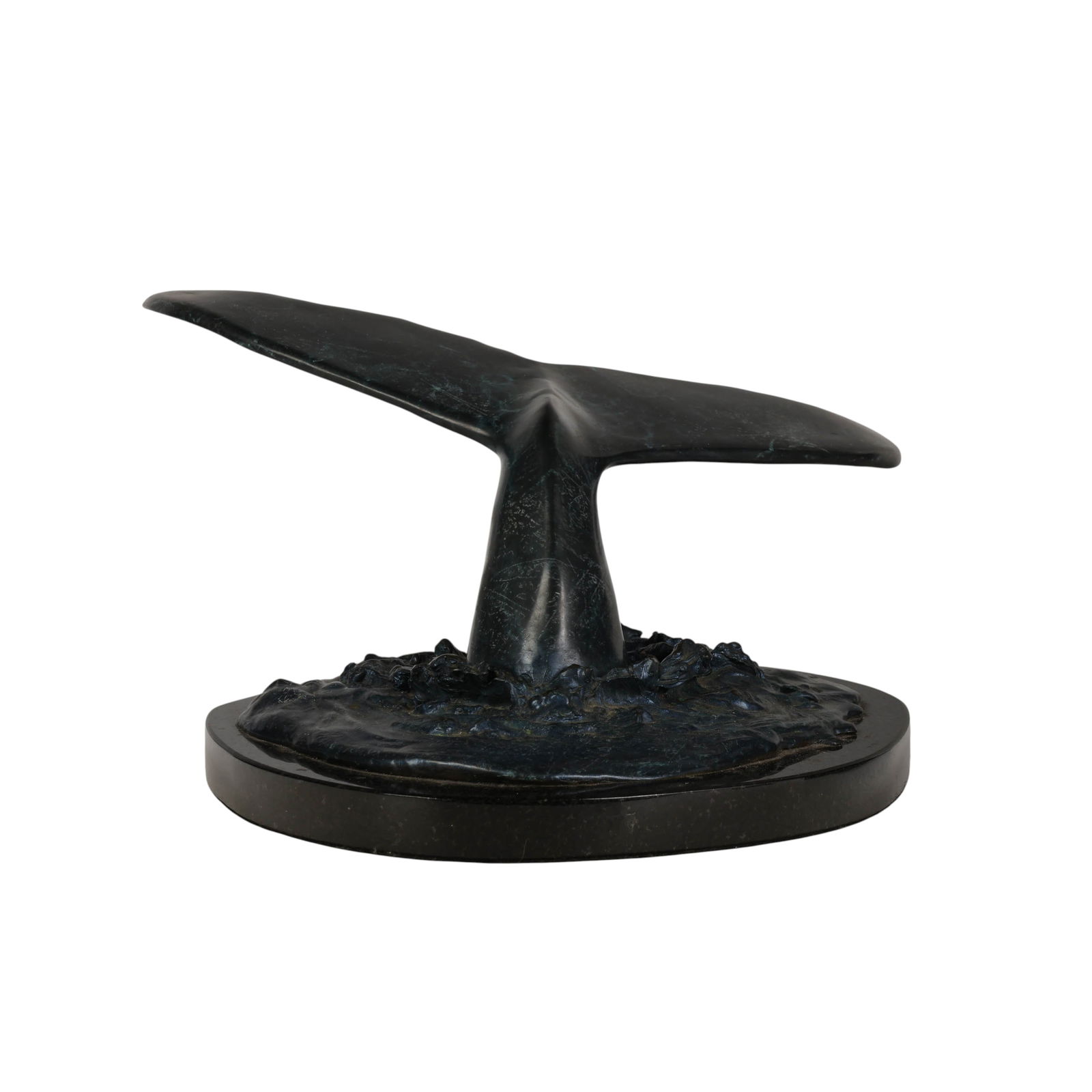 Robert Wyland b.1956 Bronze Whale Tail Sculpture: Wyland (American, born 1956), Whale Sighting, bronze sculpture depicting a whale tail emerging from textured water, mounted on an oval polished black granite stone base. The bronze is incised with