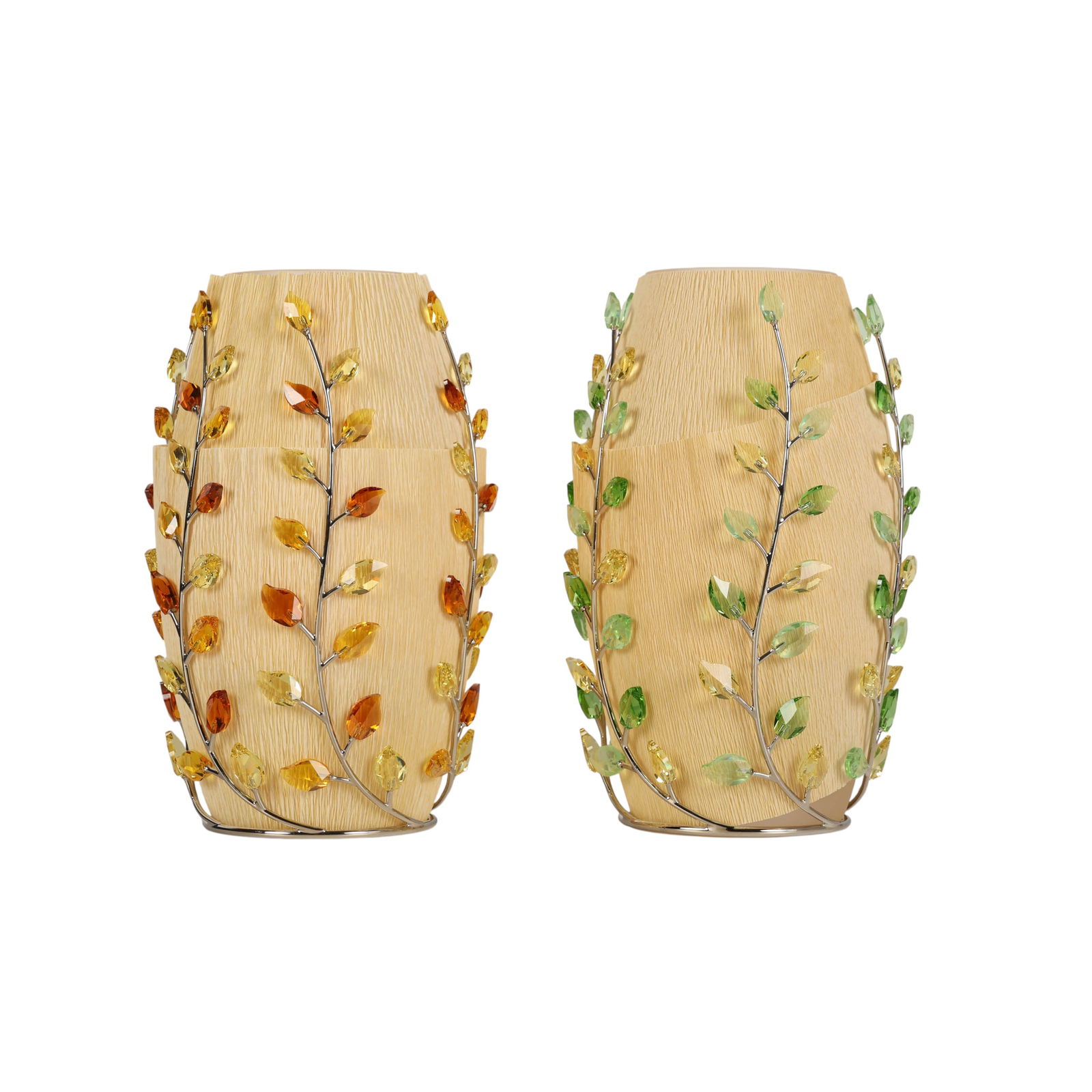 Swarovski Crystal Pair Topaz Leaves Vases w/ Boxes: Lot of two Swarovski crystal vases from the Leaves collection. Each vase is made in Austria and features decorative crystal leaf accents in green and topaz tones. Both vases are housed in Swarovski br