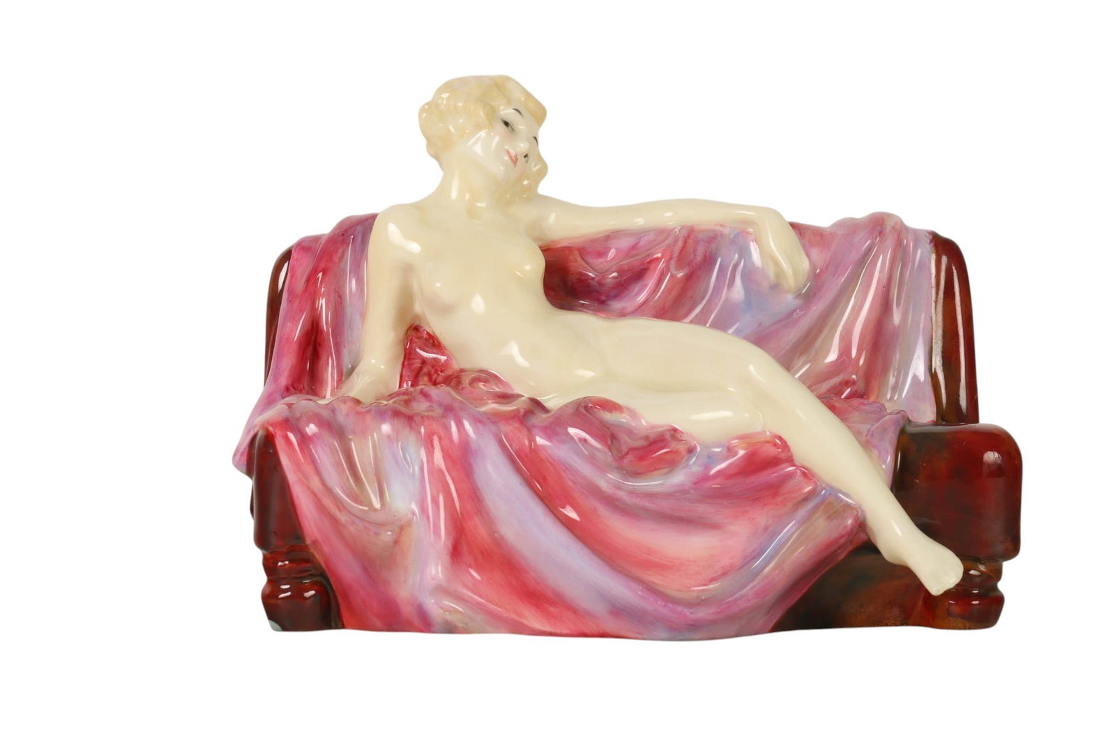 Royal Doulton Siesta HN1305 Porcelain Figurine: Royal Doulton England, Arthur Leslie Harradine (British, 1887-1965), Siesta HN1305 porcelain figurine. Depicts a reclining nude female figure resting on a draped couch. Modeled in polychrome glaze wit
